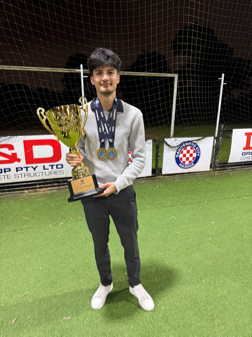 Mohamed, holding a trophy